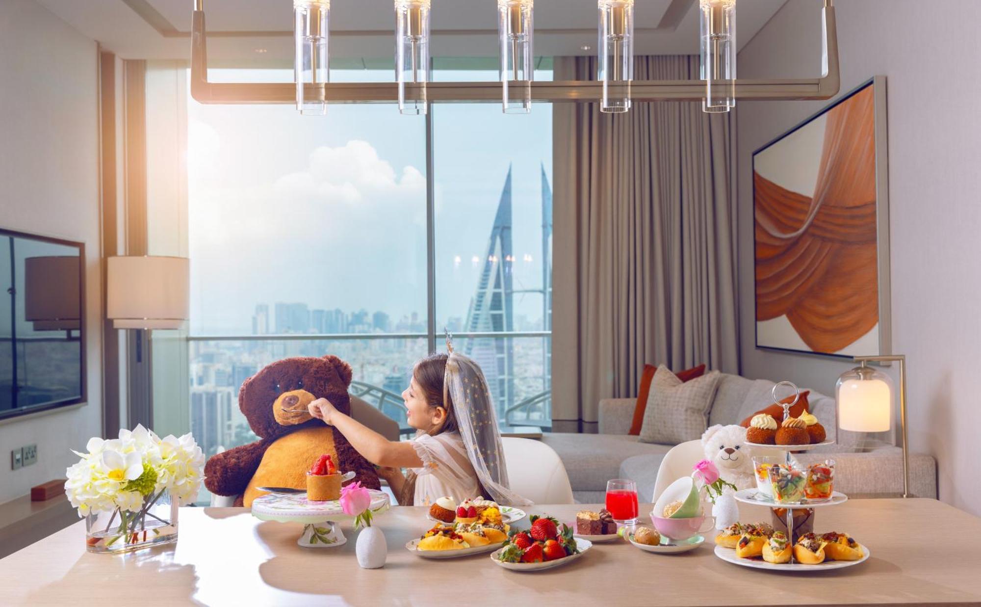 Onyx Rotana Manama Exterior foto A woman with a teddy bear